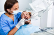 © JackF - Stomatologist girl in uniform is taking visional inspection of a man