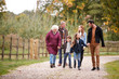 © Monkey Business - Multi Generation Family On Autumn Walk In Countryside Together