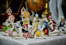 Figurines Of Ladies In Swimsuits, Antique Globe, Figurines Of Sailors, Etc. For Sale At Flea Market In Paris. Flea Markets Are Very Popular Type Of Entertainment In France. Vacation Concept.
