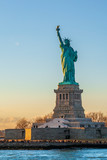 Fototapeta  - Statue of liberty vertical during sunset in New York City, NY, USA