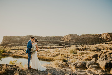 Wall Mural - Beautiful Couple on their Wedding day in front of landscape