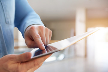 Wall Mural - a man using tablet in a business center