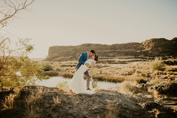 Wall Mural - Beautiful Couple on their Wedding day in front of landscape