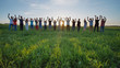 © Довидович Михаил - Students say goodbye to the school. Pupils waving their hands against the backdrop of the setting sun.