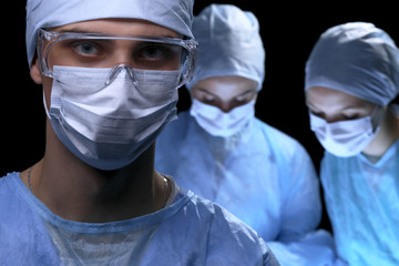 Medical team performing operation. Focus at female doctor 