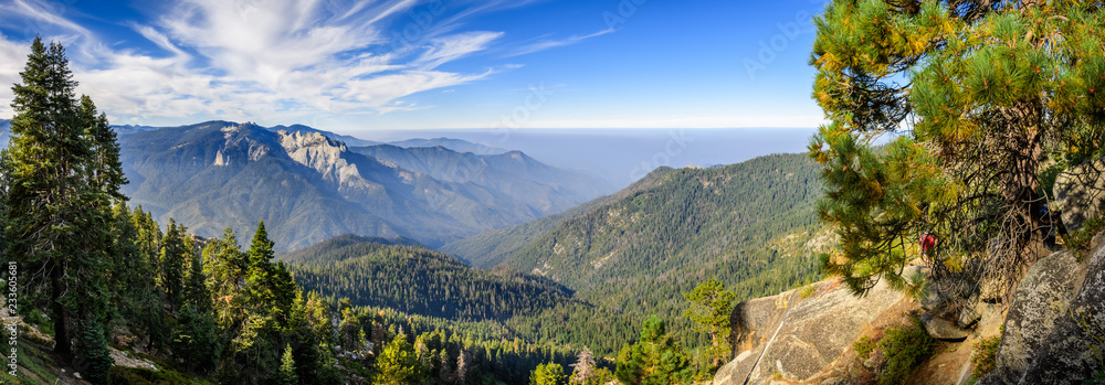 Landscape in Sequoia National Park in Sierra Nevada mountains on a sunny day; smoke from wildfires visible in the background, covering the Fresno area; - obrazy, fototapety, plakaty 