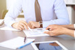 © rogerphoto - Group of business people working as a team at meeting. close-up. Colleagues or partners  discussing financial results. Successful negotiation concept