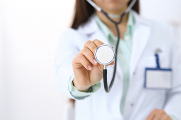 Doctor holds stethoscope head, close-up. Medical help and insurance in health care, best treatment and medicine concept