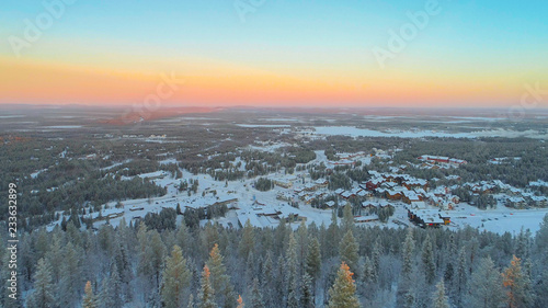 AERIAL CLOSE UP Flying over frozen pine trees, revealing Levi ski resort Finland Poster Mural XXL