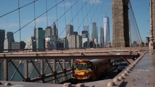 Slow Motion Shot Of American Yellow School Bus Crossing The Brooklyn Bridge