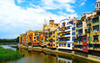 Colorful yellow and orange houses reflected in water river , in Girona, Catalonia, Spain. Church Saint Mary Cathedral at background