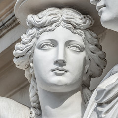 Portrait of balcony support statue of young and naked sensual Roman renaissance era women in Vienna, Austria, details, closeup