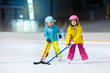 © famveldman - Children play ice hockey. Kids winter sport.
