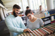 © NDABCREATIVITY - People studying together in a modern library