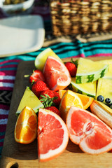 Wall Mural - Fresh fruits on a wooden board at a picnic