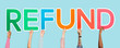 Hands holding up colorful letters forming the word refund
