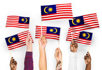 Wall Mural - Hands waving flags of Malaysia