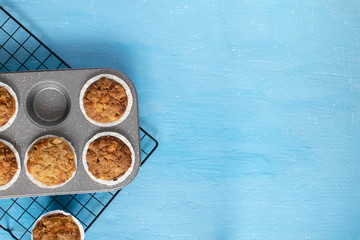 Fresh baked muffins on bright blue background