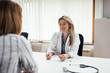 © bnenin - Attentive female doctor listening to a patient.