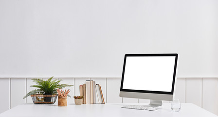 Modern computer screen desk and book object office room.