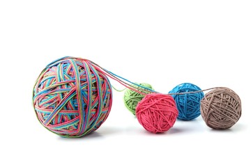 Wall Mural - colorful cotton big thread ball from four color thread isolated on white background. different color