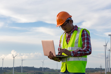 Canvas Print - Engineering use laptop checking windmill for production electricity power plant clean energy in Thailand.