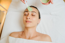 Close Up Head Shot Of A Woman Having A Green Mask Applied In Spa