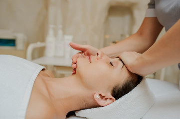 Top view of Woman having curative facial massage. 