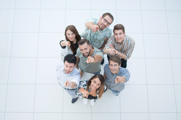 Wall Mural - top view.a group of successful young people pointing to you