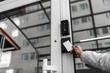 Security technologies, security systems, electronic keys, motion sensors. Hands open the door