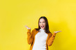 © torwaiphoto - Asian girl is surprised she is excited.Yellow background studio