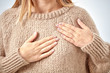 © astrosystem - Young woman with heart problem holding chest.