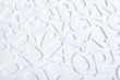  White wooden alphabet letters top view on white background