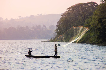 Fisherman throws a net in Lake Victoria.