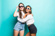 © F8  \ Suport Ukraine - Friends forever. Two mixed race cute lovely girl friends in sunglasses posing with smile on blue background