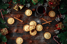 British Christmas Mince Pies With Decoration, Gifts, Green Tree Branch On Wooden Rustic Table