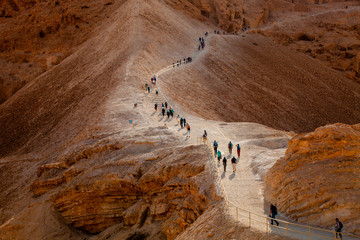 Line of tourists climbed on Masada fortrees rock. Israel.