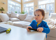 © Tierney - Little toddler boy with a TV remote control
