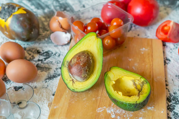 Wall Mural - close up sliced avocado on the wooden board on table while food preparation f