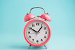 © TanyaJoy - Red alarm clock on blue background
