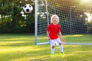 Sticker - Kids play football. Child at soccer field.