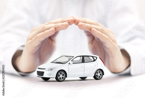 Fotografía Car insurance. Small white car covered by hands.