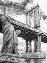 Statue Of Liberty Against Manhattan Bridge, New York. USA