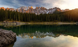 Fototapeta Natura - Sunset at Carezza lake with beautiful reflections of dolomites mountains