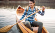 Smiling travel girl enjoy canoeing