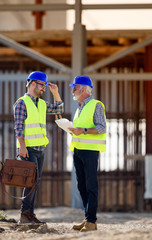 Engineers talking at building site