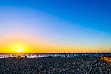 Wall Mural - Glenelg beach with people at sunset