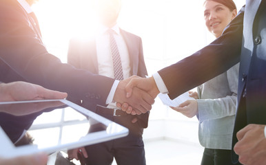 Wall Mural - employees look at the handshake business partners