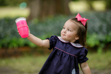 Little Toddler Preschool Girl in Navy Dress Drinking from Sippy Cup