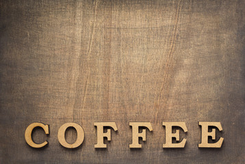 Sticker - coffee letters at old wooden background